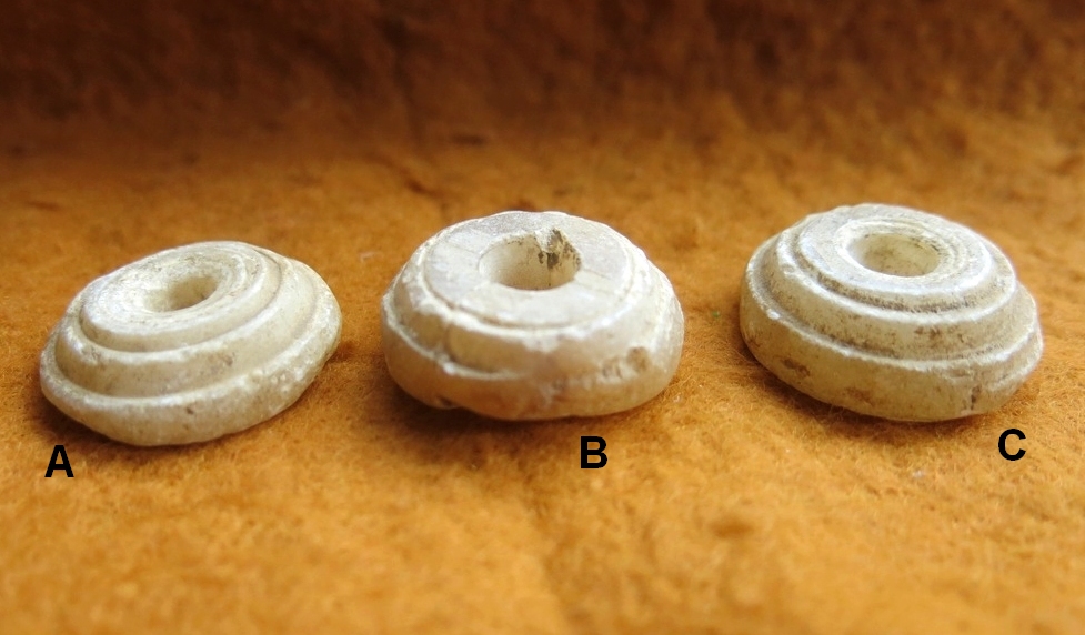 123a. Three alabaster Near Eastern spindle whorls.  