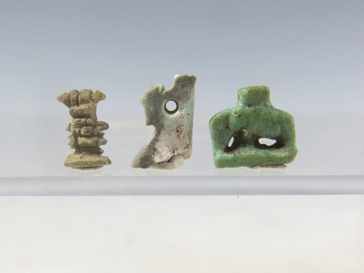 6130. Three very small faience amulets