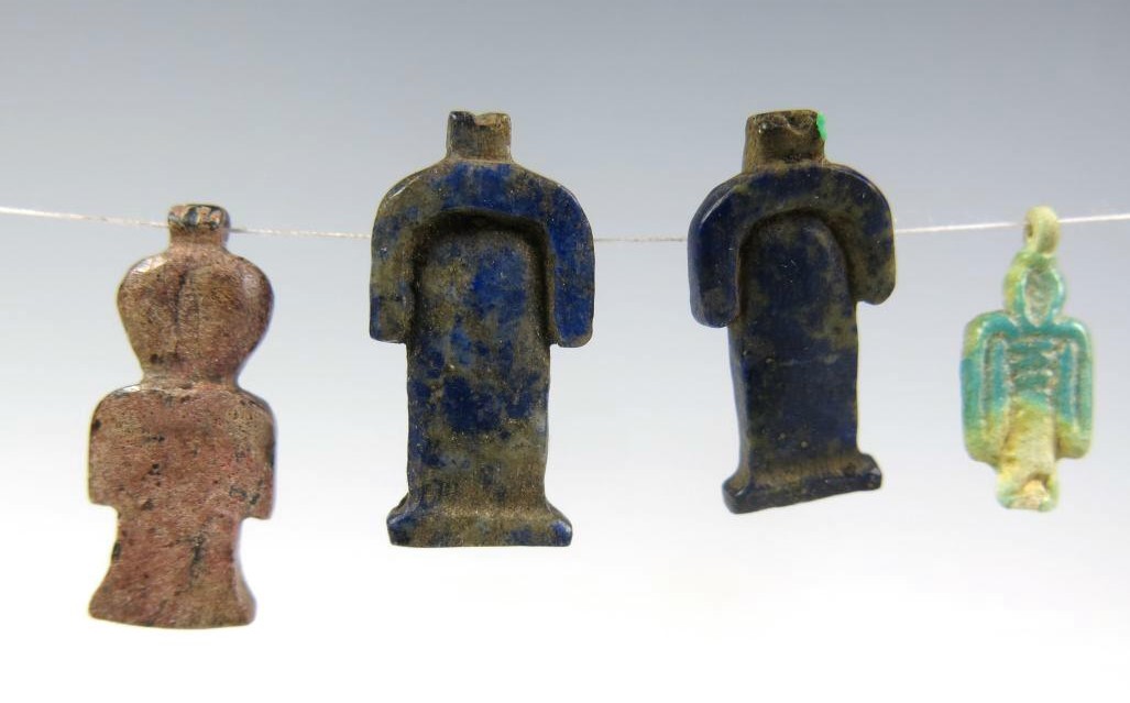 5855.  Four Tit amulets