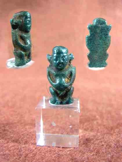 4884. Very dark small blue-green faience amulet of Ptaikos